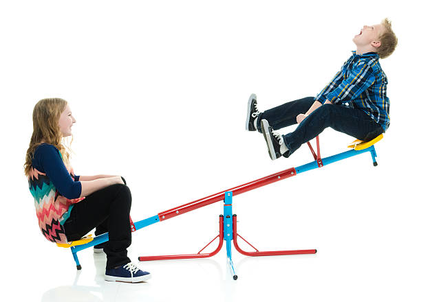 Kids playing on teeter totter Kids playing on teeter totterhttp://www.twodozendesign.info/i/1.png 12 13 years pre adolescent child female blond hair stock pictures, royalty-free photos & images