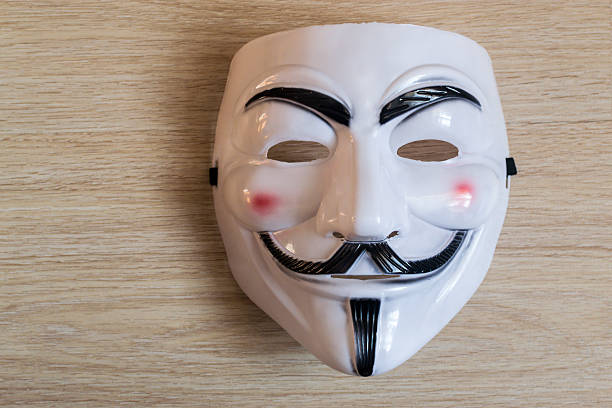 Guy Fawkes Mask A Wooden Background Stock Photo - Download Image Now - Guy Fawkes Mask, Guy Fawkes, Mask - Disguise - iStock