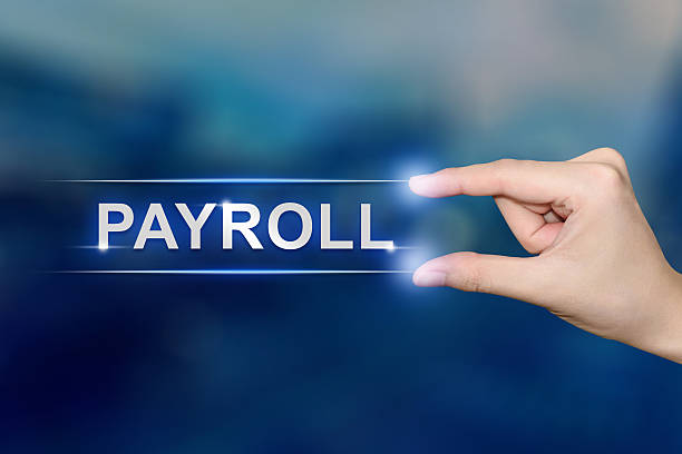 hand clicking payroll button stock photo