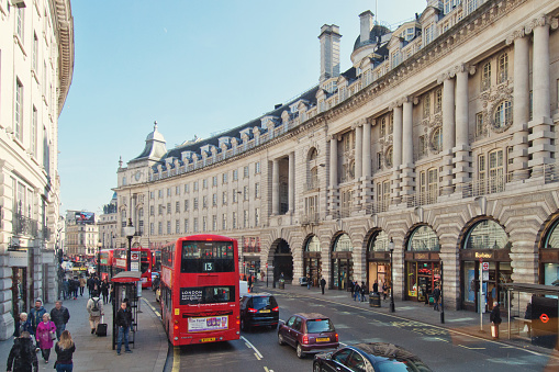 London, UK - March 14, 2016: People walking and shopping on the sidewalks of the major shopping street of Regent Street in London.