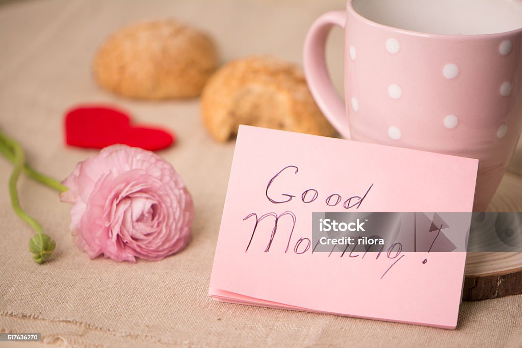 Cup of coffee and cookies on the table. Wishing a Cup of coffee and cookies on the table. Wishing a nice day. Pleasant surprise a friend or loved one. Note on the table next to the coffee and cookies.  Breakfast Stock Photo