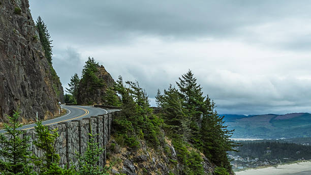 istock Clean winding road through mountain and ocean 517636626