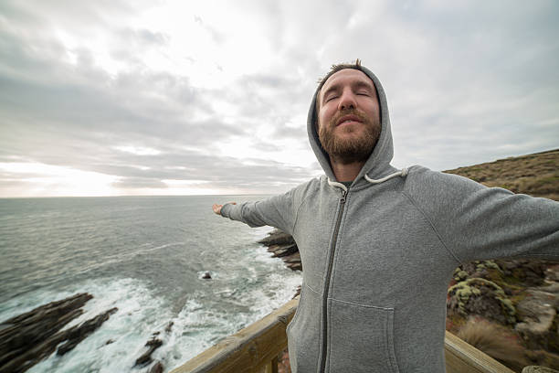 istock Cheerful young man relaxes by the sea 517637374