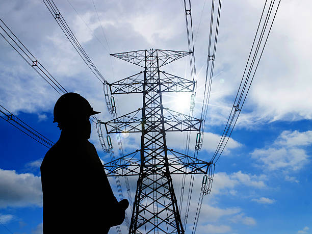 istock silhouette of engineers standing at electricity station 517638936
