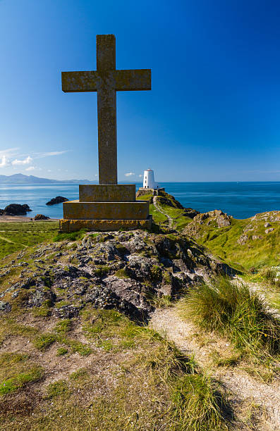 istock Cross and lighthouse on Llanddwyn Island, Anglesey 517639300