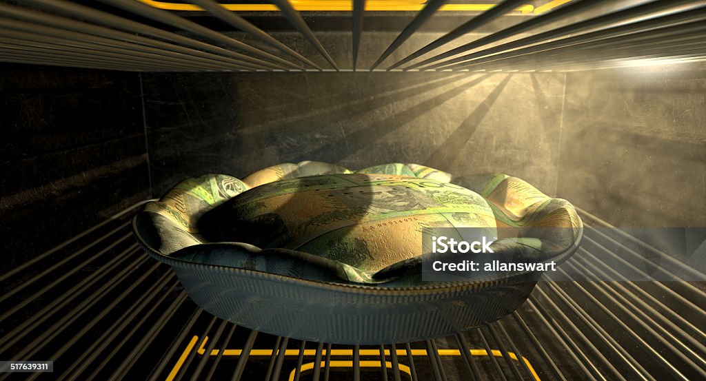 Australian Dollar Money Pie Baking In The Oven A closeup concept of a money pie made with Australian Dollar bank notes baking in a heated oven Appliance Stock Photo