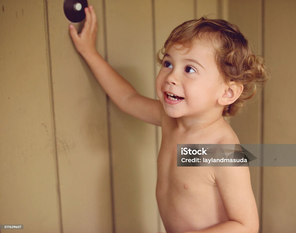 Stop Ringing The Doorbell - With Toddler Laughing toddler child keeps ringing the doorbell Child Stock Photo