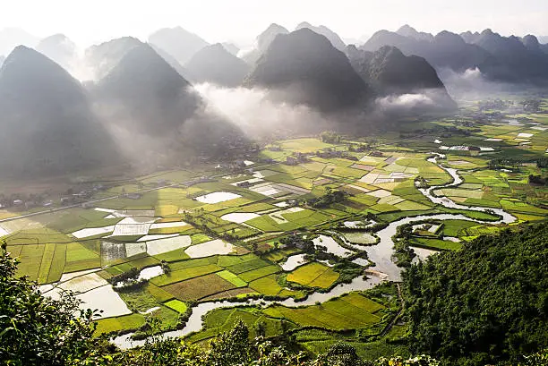 Aerial view of multiple mountain peaks and rice field in Vietnam