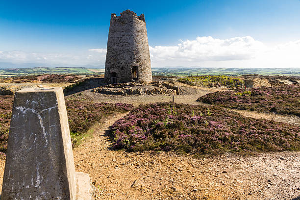 istock Trig point with derelict windmill, Parys Mountain. 517640772