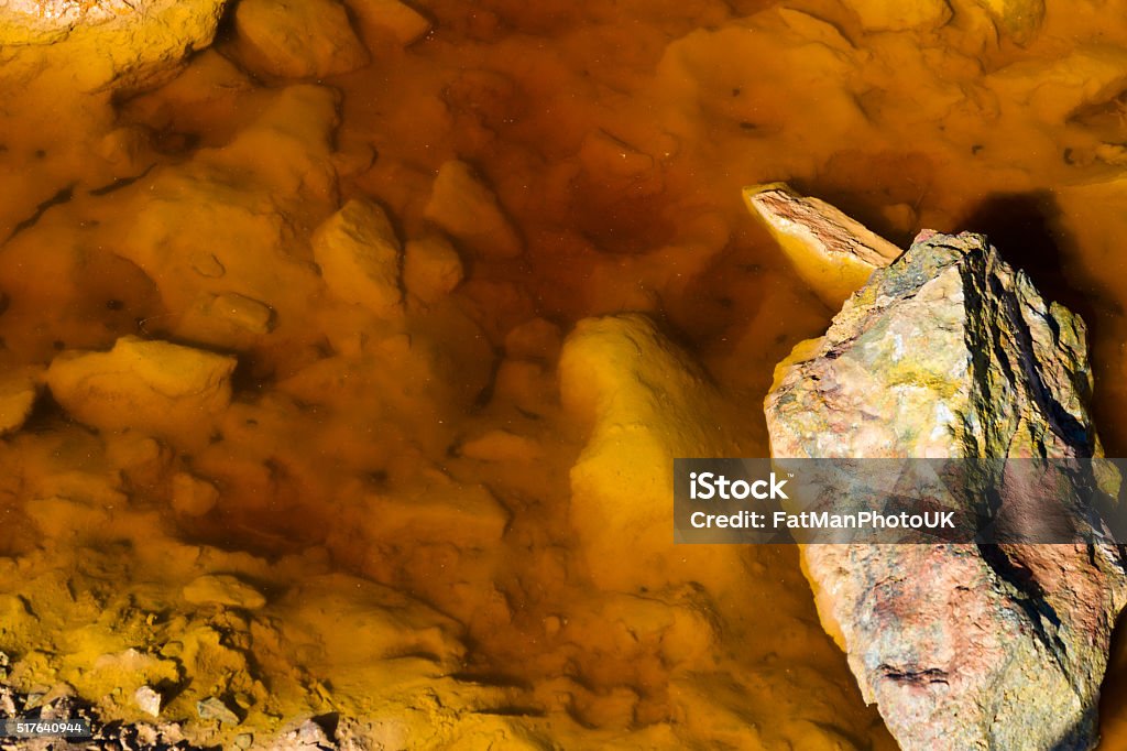 Copper mineral stained water Orange, Stained water on derelict copper mining area of Parys Mountain. Amlwch, Anglesey, Wales, United Kingdom Anglesey - Wales Stock Photo