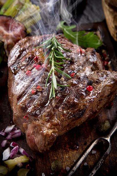 istock Beef steak on wooden table 517642129