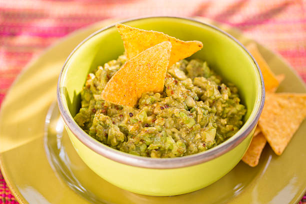istock Bowl of Guacamole and nachos, sun light 517642141