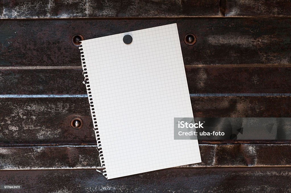 Notepad in front of a metal background Memo, from squared paper with copy space against a metal background. Backgrounds Stock Photo
