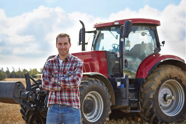 istock Proud farmer standing in front of tractor 517642851