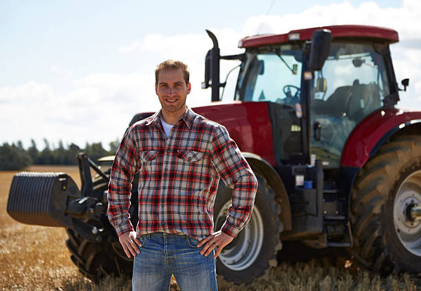 istock Proud farmer standing in front of tractor 517642855