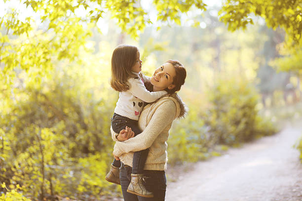 istock Happy mom and child in autumn park 517642873