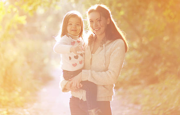 istock Happy mom and child outdoors in autumn park 517642875