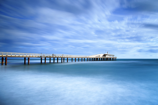 Modern steel pier in a cold atmosphere Long exposure photography in Lido Camaiore, Versilia, Tuscany, Italy, Europe