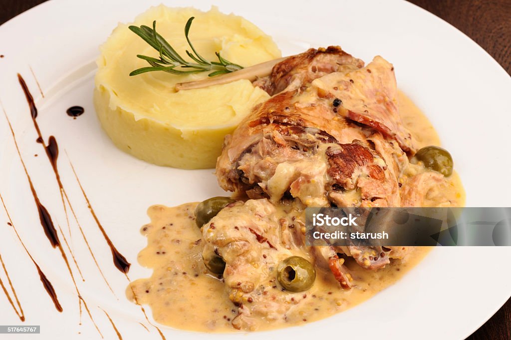 Rabbit legs with potato puree and rosemary Stewed rabbit legs with potato puree and rosemary Animal Body Part Stock Photo