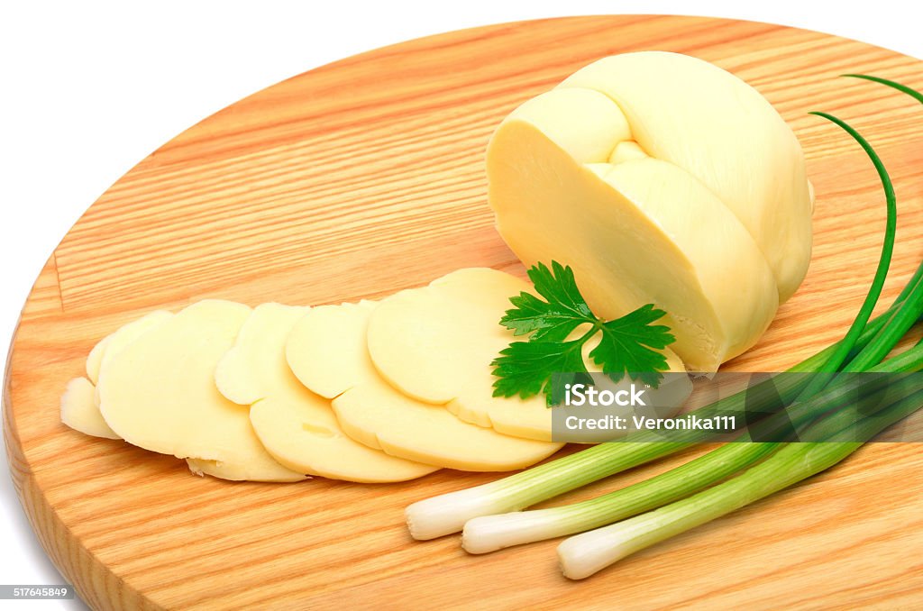 Cheese,cheese slices and green onion on the wooden board Cheese,cheese slices and green onion on the wooden board isolated on white Breakfast Stock Photo