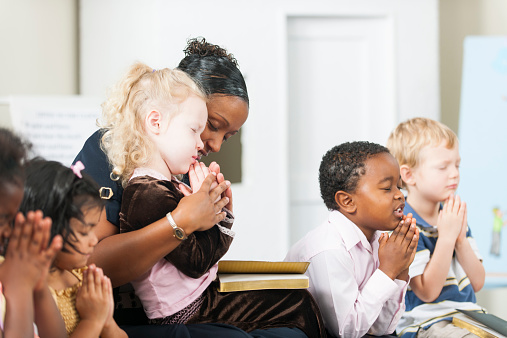 A group of multi-ethnic children at Sunday School in a real church classroom