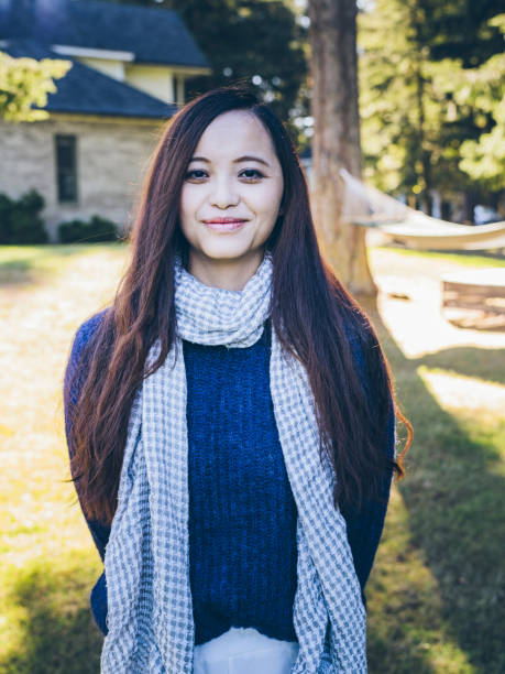 istock smiling asian woman standing with hammock 517653284