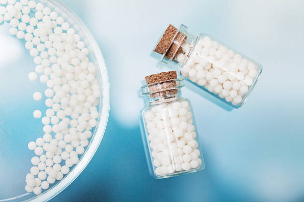 istock homeopathic pills lying on petri dish in a laboratory 517656012