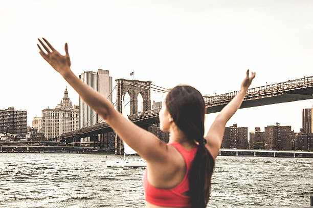 istock Young woman runner with arms raised 517660518