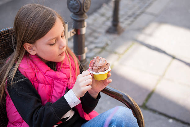 istock Cute little girl with ice cream 517661078