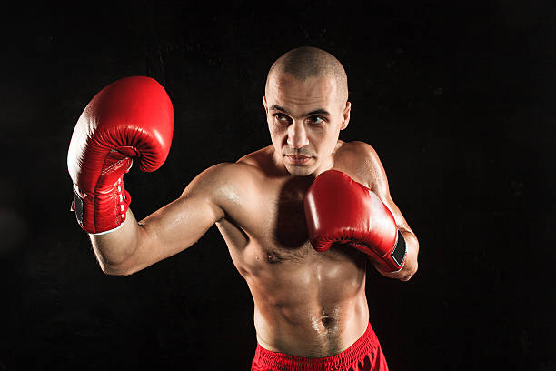 istock The young man kickboxing on black 517661868