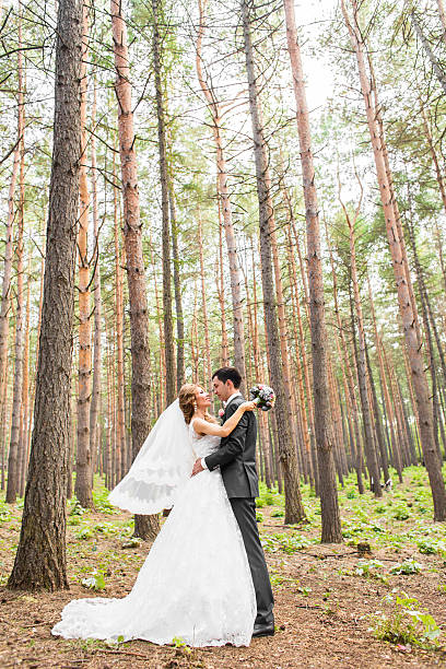 istock Elegant bride and groom posing together outdoors on a wedding 517662620