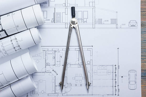 istock Architect worplace top view. Architectural project, blueprints, blueprint rolls and 517662892