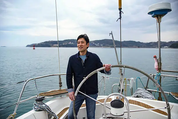 Photo of Mature man driving a lusury yacht