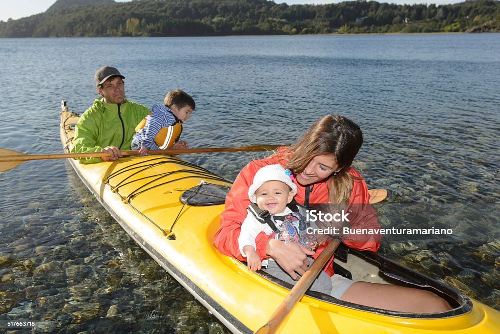 Family Holiday Family enjoying the holidays in the lakes of Patagonia, together with sea kayaking. Activity Stock Photo