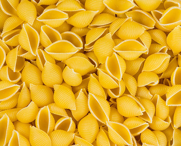 istock Italian Pasta conchiglie background texture 517663910