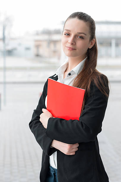 istock Succesful confident business woman holding folder 517667612