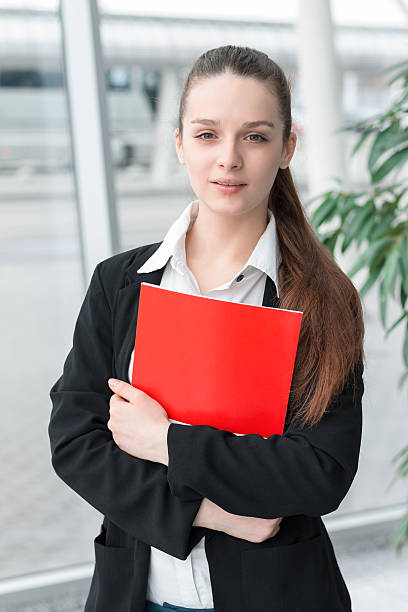 istock Succesful confident business woman holding folder 517667630