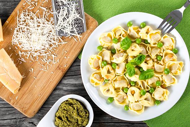 istock tortellini with green peas, fried Pine nuts,  top view 517667788