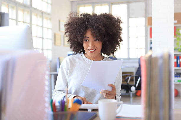 istock Front view of working young woman on her desk 517668692
