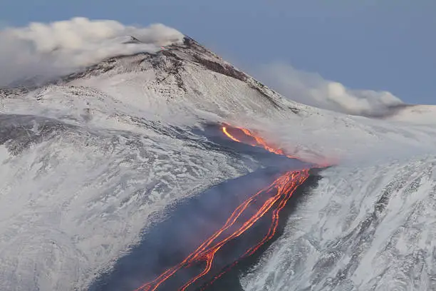 Erupting volcano Etna in winter. rivers of lava down into the Valle del Bove. January 26, 2014