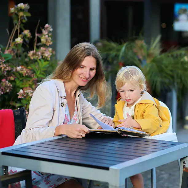 Photo of Mother and daughter in outdoors cafe