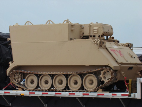 beige Armored tank in tow
