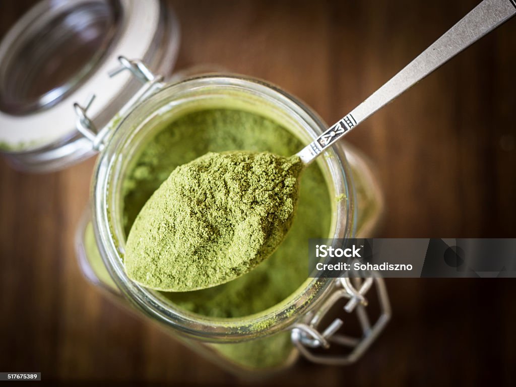 Moringa powder Moringa powder on a spoon. Green Color Stock Photo