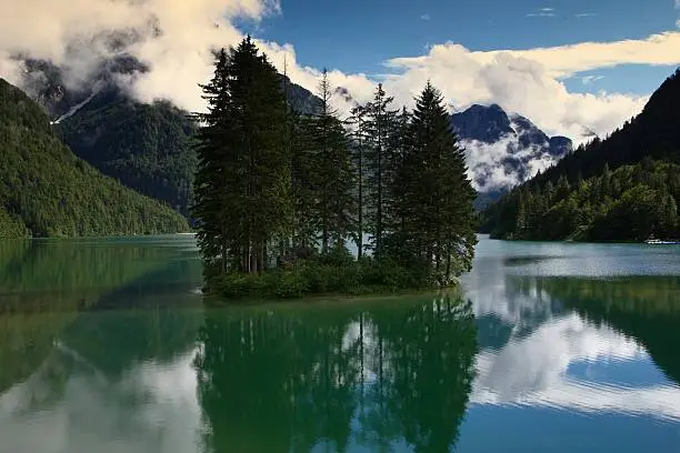 Insel with a few trees in the middle of lake in austria