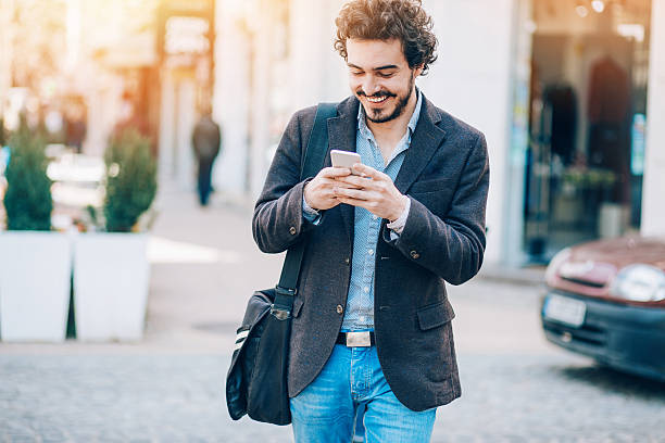 istock Checking messages outside on the street 517675994