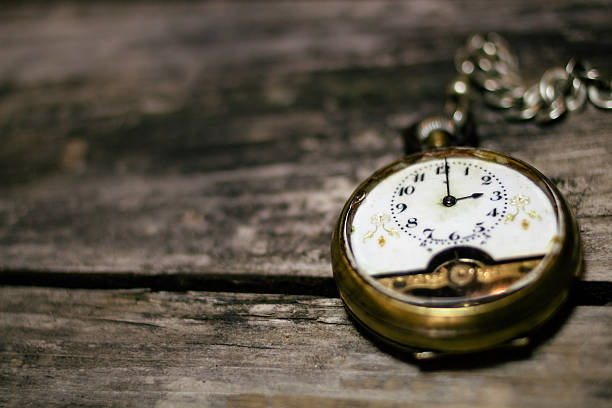 istock Pocket watch on rustic wooden board background. 517676570