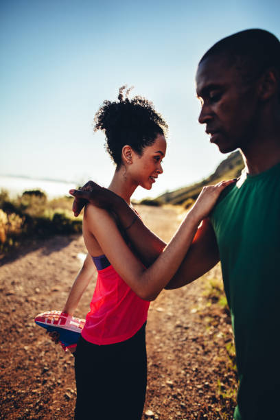 istock Young couple warming up before running outdoors 517677072