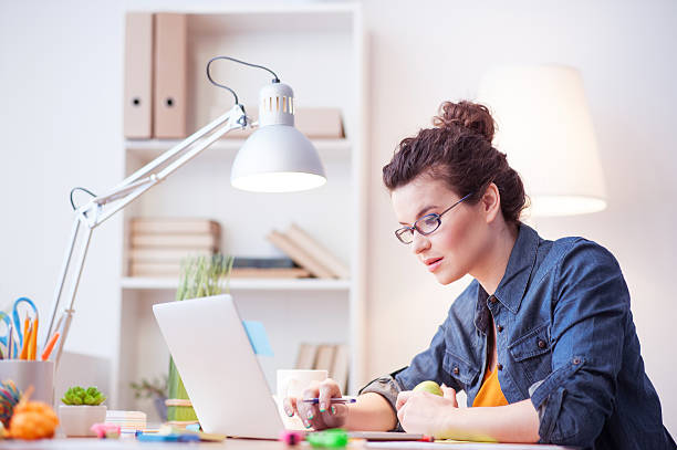 istock Attractive female freelancer is working at home 517677866