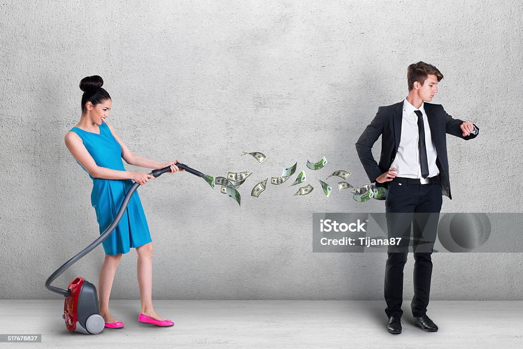 Woman vacuuming money out of man's pocket Currency Stock Photo