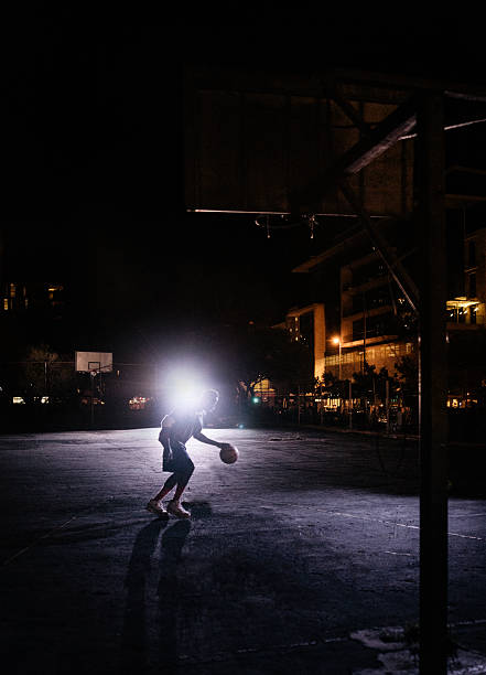 istock Basketball Player Practicing Alone on Court at Night 517679102
